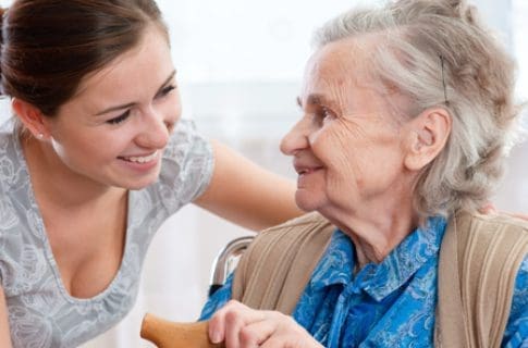 A Caregiver Taking Care of the Old Woman